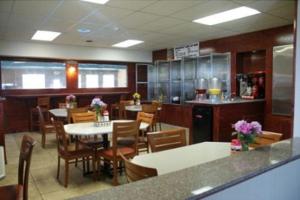 a restaurant with tables and chairs and a kitchen at America's Best Value Inn-Marion in Marion