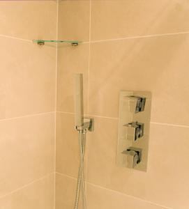 a shower with a shower head in a bathroom at The Jade in London