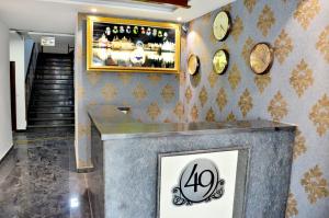 a lobby with clocks on the wall and a counter at Hotel 49 in Amritsar