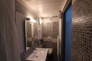 a bathroom with a sink and a toilet at Residence Hoteliere Sarah Bernard in Le Palais +45 photos