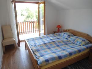 a bedroom with a bed and a sliding glass door at Galesic Apartments & Rooms in Korenica
