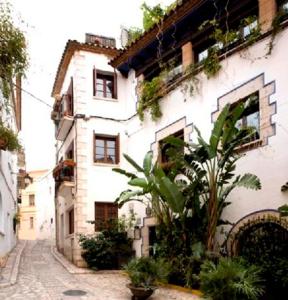 
a large building with a bunch of trees around it at Boutique Hotel Davallada- Adults Only in Sitges

