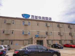 a building with a car parked in front of it at Bestay Hotel Express Shenyang Imperial Palace Huaiyuanmen Subway Station in Shenyang