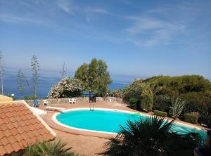 a swimming pool with a view of the ocean at Residence Covo degli Dei in Milazzo