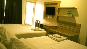 Postel nebo postele na pokoji v ubytování Hotel Ashoka