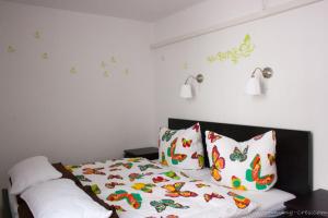 a bedroom with a bed with butterflies on the wall at Cres in Cres