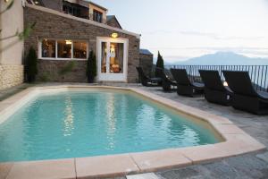 a swimming pool with chairs next to a building at Casa Di Lucia Mi-Hotel in Mazzola