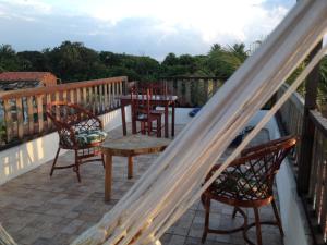 a deck with chairs and a table on a balcony at B&B Pedra do Meio in Paracuru