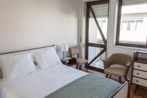 A bed or beds in a room at Family Espinho Porto Guesthouse