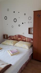 a bedroom with a bed with a wall with faces on it at Apartment Krizanovic in Malinska