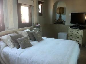 
a bedroom with a bed and a television at Boutique Hotel Davallada- Adults Only in Sitges
