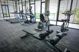 a gym with several rows of exercise machines in a building at Baan Peang Ploen by Pattama in Hua Hin