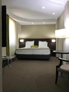 Postel nebo postele na pokoji v ubytování Hotel Alex