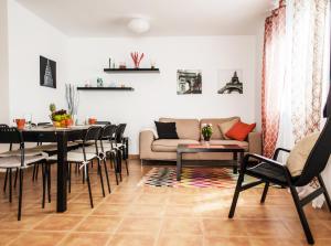 a living room with a table and chairs and a couch at Bhavana Surf House in Corralejo