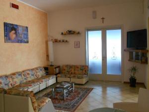 a living room with couches and a cross on the wall at Hotel Vevey in Rimini