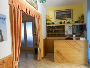 a room with a door open to a room with a desk at Hotel Vevey in Rimini