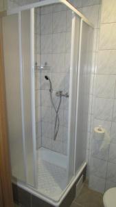 a shower with a glass door in a bathroom at Willa Velde in Karpacz