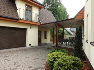 a house with a garage and a patio at Helsinkis in Anykščiai