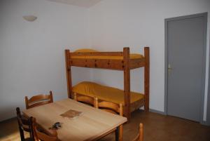 a room with a table and a bunk bed at Residence Ribellinu in Pianottoli-Caldarello