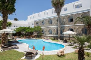 a swimming pool in front of a building at Galinos Hotel for adults only in Parikia