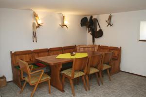 a dining room with a wooden table and chairs at Regina's Guesthouse in Balchik