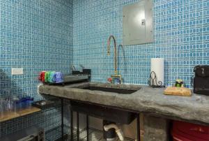 uma casa de banho com um lavatório e paredes em azulejos azuis em 315 Recinto Sur Old San Juan em San Juan
