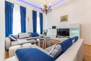 a living room with a couch and a tv at E&E Apartments in Ljubljana