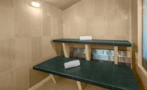 a room with two green shelves in a bathroom at Hotel Embassy Park in Bogotá