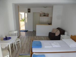 a living room with a bed and a table at Guesthouse Bracanović in Hvar