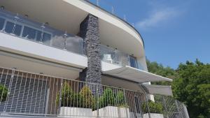 a building with a balcony with plants on it at Como Lake Residenza Armonia in Gera Lario