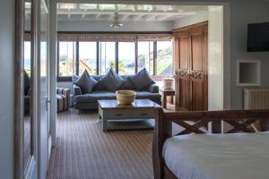 a living room with a bed and a couch at Lulworth Lodge in Lulworth Cove