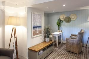a living room with a table and two chairs at Lulworth Lodge in Lulworth Cove