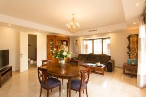 a living room with a table and a couch at Villa Las Lomas de Marbella in Marbella