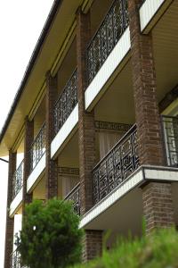 a brick building with balconies on the side of it at FAVAR Carpathians in Skhidnitsa