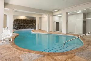a large swimming pool in a hotel room with a chair at Country Inn & Suites Downtown Convention Center by Radisson, Gatlinburg, TN in Gatlinburg