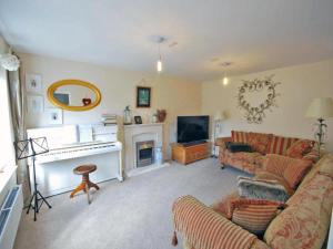 a living room with a couch and a fireplace at Luxurious House in Cornwall in Truro