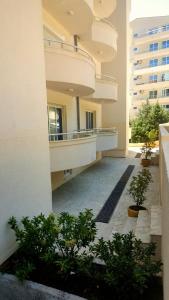 a hallway of a building with plants in a courtyard at anja apartment in Petrovac na Moru