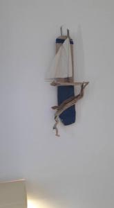 a shelf on a wall with a boat on it at Pavlos Rooms in Livadia