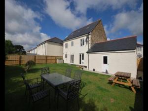 a yard with a table and chairs and a house at Luxurious House in Cornwall in Truro