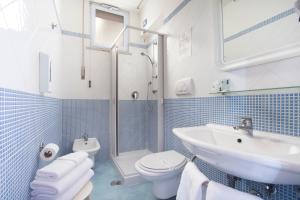 a blue and white bathroom with a sink and a toilet at Hotel La Meridiana in Sorrento