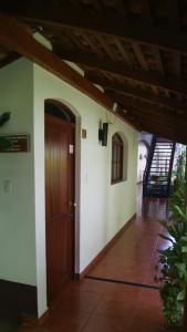 a hallway of a house with a wooden door at Hotel Cacique Adiact in León