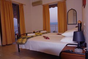 a bedroom with a large bed with flowers on it at Rodon in Loutra Edipsou