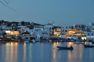 a view of a town with white buildings at night at Vrahos Boutique Hotel in Karavostasi