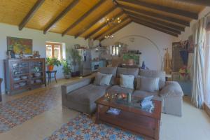 a living room with a couch and a coffee table at Casa de Campo La Estancia in Tarifa