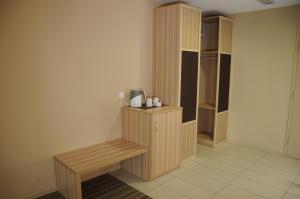 a room with a wooden bench and a closet at Zara's Boutique Hotel @ Harbour City in Kota Kinabalu +10 photos