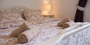 a white bed with towels on top of it at Apartment Zlatni Potok - View of the Old Town & 15 Minute Walk to the Center in Dubrovnik