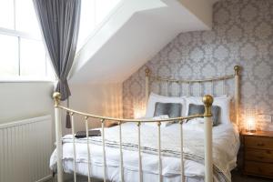 a bedroom with a bed and a window at Ellerbrook House in Windermere