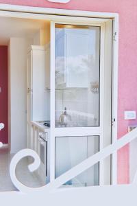 a kitchen with a glass door and a sink at Villa Alba in Acitrezza