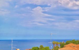 a view of the ocean and a blue sky with clouds at Villa Alba in Acitrezza