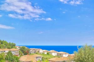 a group of houses on a hill next to the ocean at Villa Alba in Acitrezza